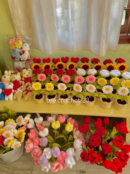 A full view of a diverse bulk order, including potted flowers, amigurumi bunnies, and single stem tulips.