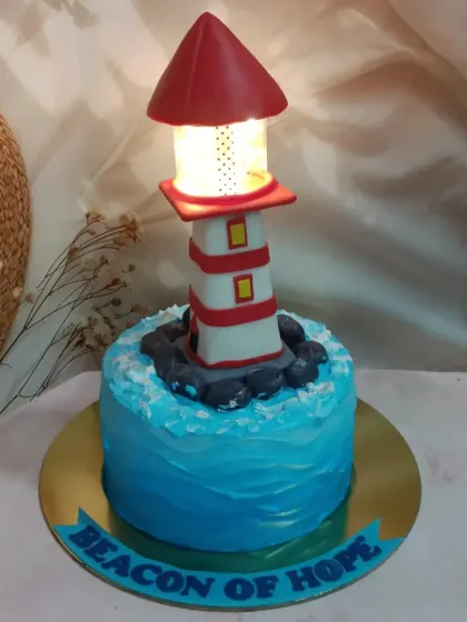 A beacon of hope, and a delicious cake. This lighthouse cake features a working light at the top, making it a unique and symbolic centerpiece.