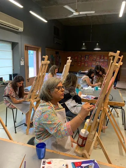 A view of our adult Picasso workshop in session, with multiple artists working at their easels in our spacious studio.