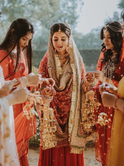 The bride participates in the Kalire ceremony with her bridesmaids, a cherished and emotional Punjabi wedding tradition.