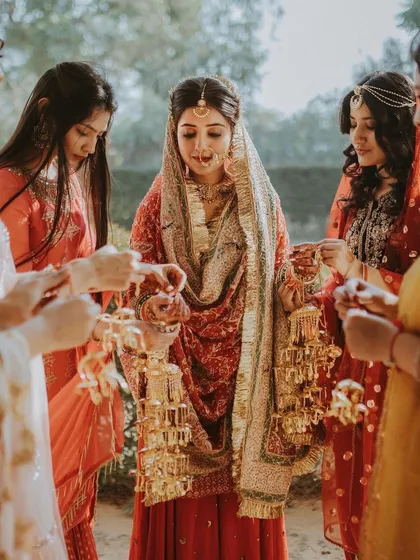 A bride during the Kalire ceremony, surrounded by her bridesmaids.