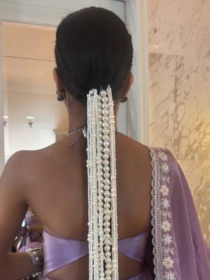 The full back view of the pearl waterfall braid. This is a show-stopping hairstyle that is perfect for a high-fashion event or a modern bride.