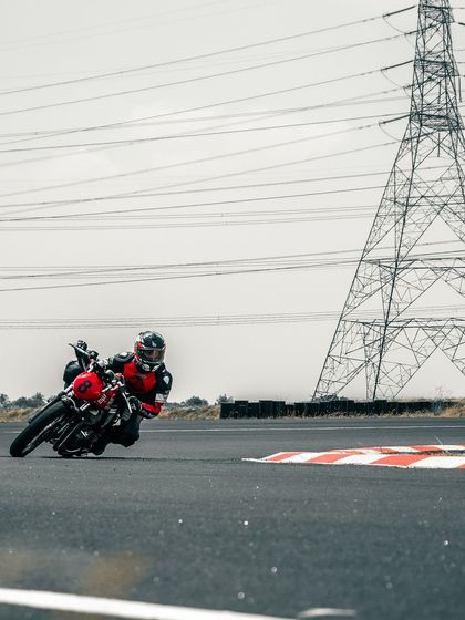 A rider on a GT 650 cornering with the power lines in the background.
