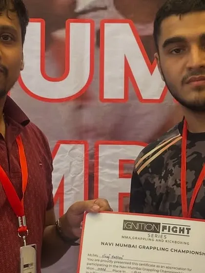 Vraj receiving his certificate for a gold medal performance in grappling. His flawless rear-naked choke choke was a display of pure technique and control.