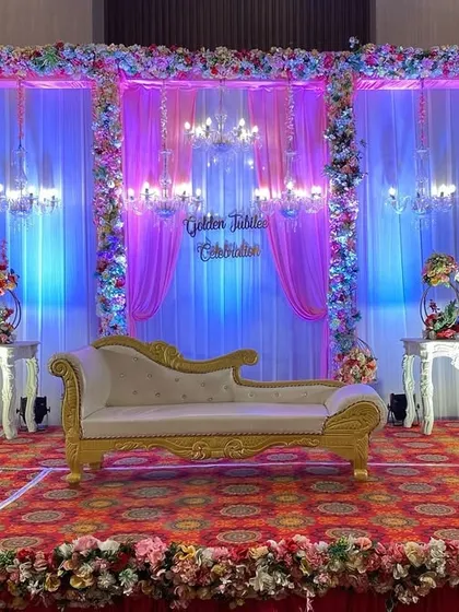 The same golden jubilee stage, transformed with purple and blue ambient lighting. This shows how I use lighting to completely change the mood of a space for different parts of the event.