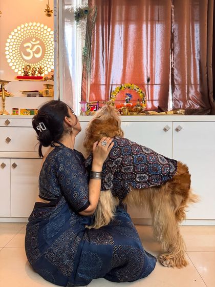 A candid moment of love between me and my firstborn, Posto, during the Janmashtami puja.