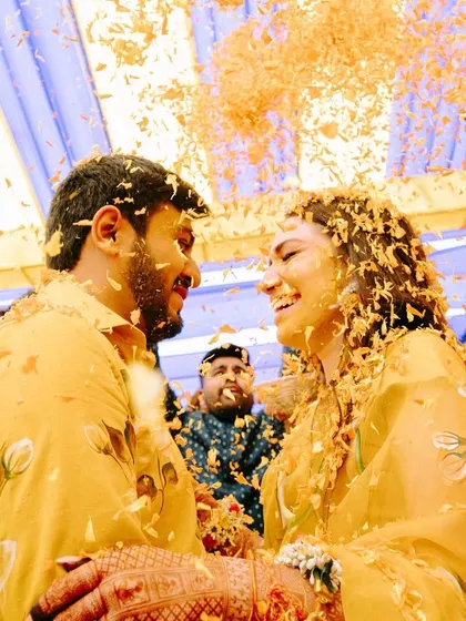 A moment of pure joy and love, as the couple is showered with flowers during their Haldi.