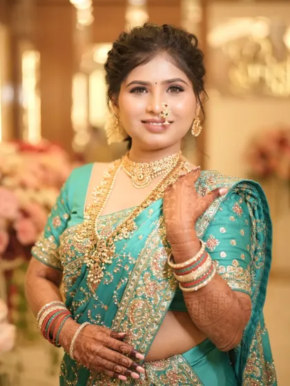 This bride is shining from within. A beautiful reception look in a turquoise saree with intricate embroidery.