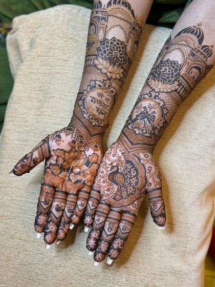 The complete design on both hands, with a beautiful mix of floral, peacock, and architectural motifs, all tied together with a Bengali quote.