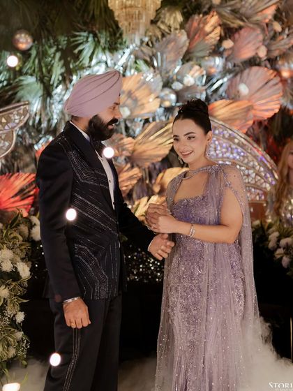 A candid moment of interaction between the couple during their reception, their smiles reflecting the joy of the celebration.