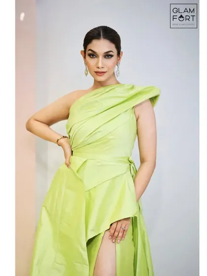 A chic and modern look in a lime green dress. The makeup is clean and sharp, with a classic winged liner and a neutral lip to keep the focus on the outfit.