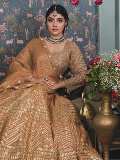 A full-length view showing how the makeup, hair, and outfit come together. The elegant updo and soft glam makeup create a cohesive and regal look, perfect for a reception or engagement ceremony.