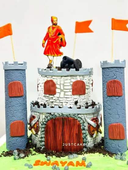 A cake designed as a fort for a Chhatrapati Shivaji Maharaj theme. This cake celebrates Maharashtrian history and is a proud creation.