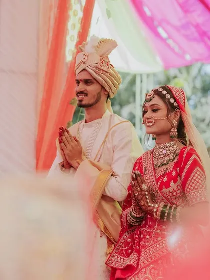 An over-the-shoulder shot of the couple during the wedding ceremony, capturing their expressions of devotion.
