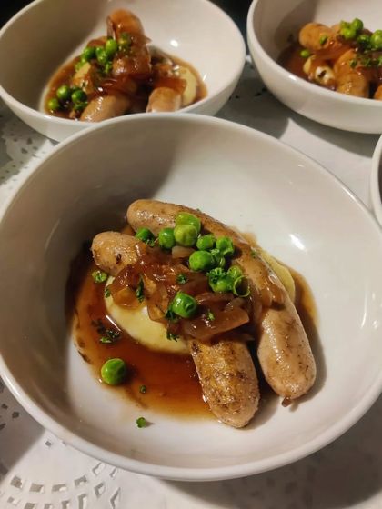 We also master comforting classics. Here are our Bangers and Mash, served in individual bowls with a rich onion gravy for a casual yet gourmet feel.