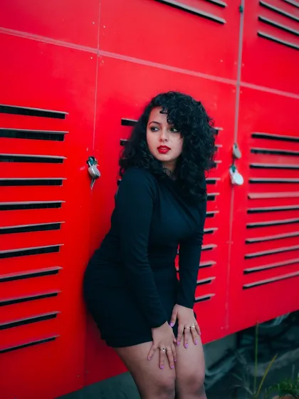 A duplicate of image 160, this shot uses a bold red background to create a high-impact, modern fashion portrait.