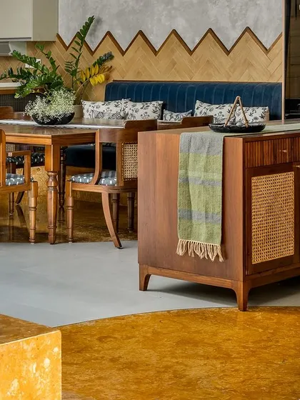 Another angle of the dining area, focusing on the custom sideboard with its cane-paneled doors. Small details, like the frog statue, add a personal and whimsical touch.