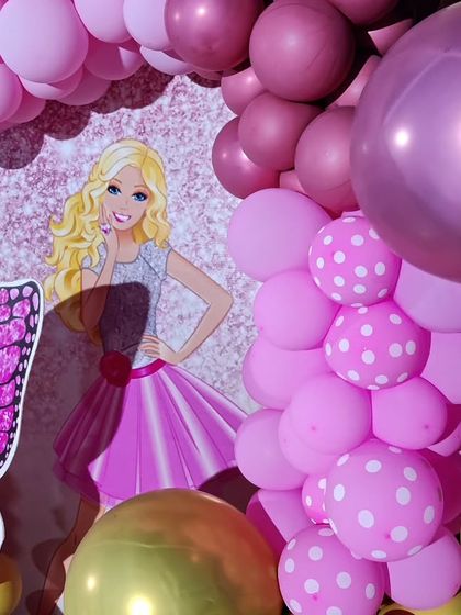 A close-up of a princess-themed backdrop, showing the detailed Barbie and butterfly graphics.