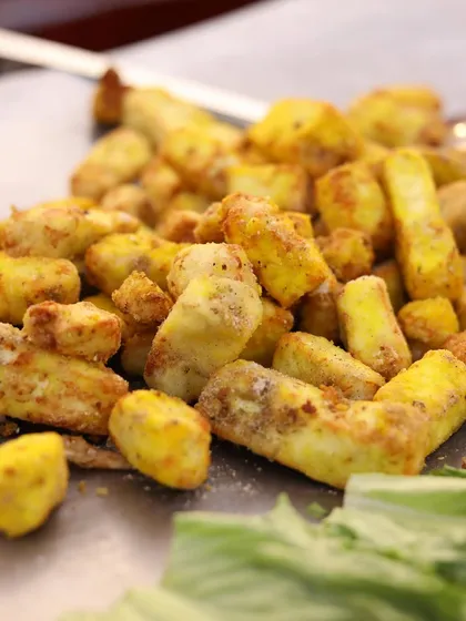 A close-up of perfectly grilled and seasoned paneer tikka, fresh off the tawa at one of my live cooking stations. I focus on using quality ingredients to deliver incredible flavor in every bite.