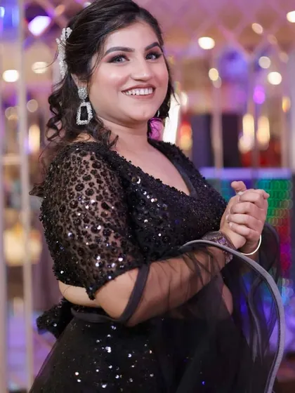 A close-up of the glamorous makeup and hair. The soft curls and sparkling accessories complete the look.