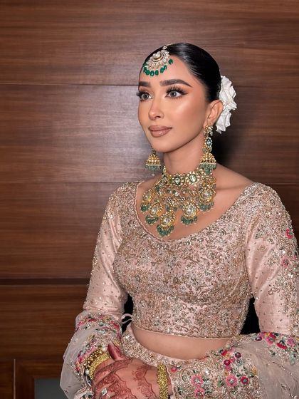 A side profile of this beautiful look. The white flower in her hair adds a lovely touch.