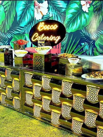 A salad bar doesn't have to be boring. I designed this vibrant, tropical-themed salad and starter counter with a neon sign for a fun, fresh, and healthy option at an outdoor event.