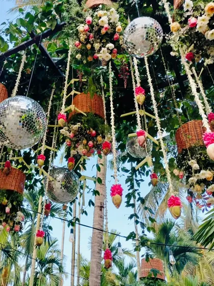 A daytime view of the hanging disco ball and floral decor, showing how it beautifully catches the light and adds a whimsical touch to the celebration.