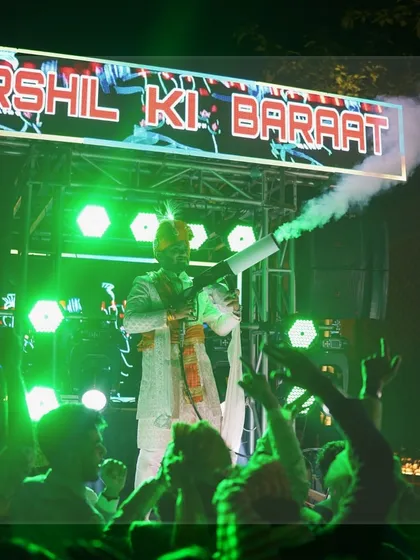 The groom makes a high-energy entrance at his baraat. Standing on a moving truck with a custom LED sign and a cold smoke gun, he set an electrifying tone for the procession.