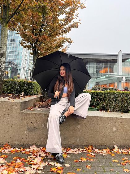 A happy moment captured in the autumn rain, showcasing a relaxed and stylish outfit.