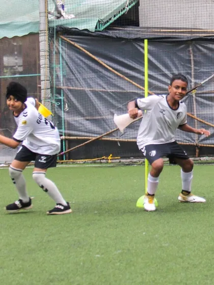 Two players engage in a dynamic agility and coordination drill, mirroring each other's movements to improve reaction time and footwork.