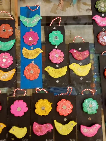 A close-up of the colorful clay birds and flowers. The glitter adds a bit of sparkle that the toddlers absolutely love.
