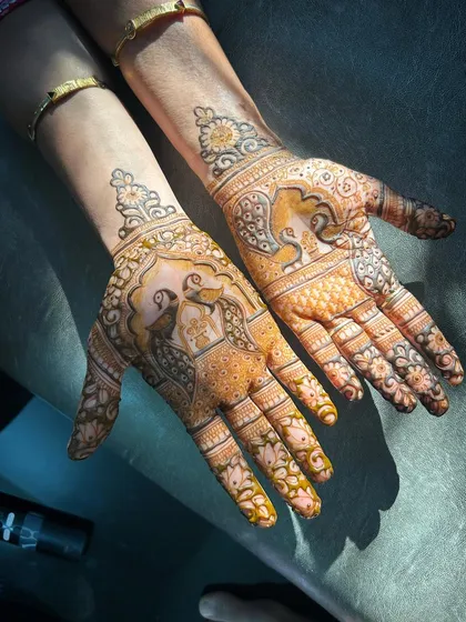 Here, the beautiful golden glow of the henna stain highlights the details of the peacock and elephant motifs. The sunlight catches the design, showing how the color deepens and enriches the artwork.