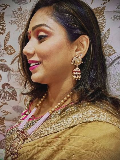 A client looking lovely in a long, elegant necklace with a pink beaded pendant. This is a great rental option for guests who want a statement piece that is not a choker.