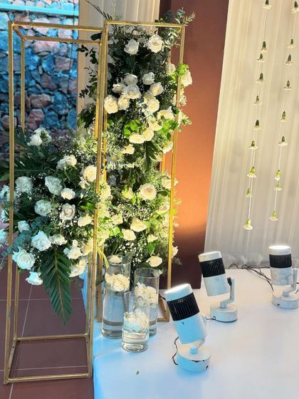 These tall, golden floral stands are perfect props for a wedding or reception. They can be used to frame a backdrop or line an entryway, adding a touch of glamour and elegance.