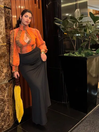 The full thrifted look. I paired the busy top with a simple black maxi skirt to balance it out. It’s all about creating harmony in your outfit.