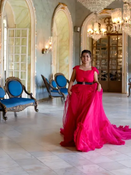 This shot shows the full trail of the pink gown in a magnificent hall. It's perfect for creating a sense of grandeur and elegance in your pre-wedding photos.