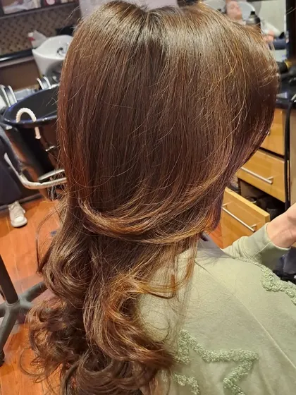 The back view of the layered cut and blowout. You can see the distinct layers that create shape and reduce weight, allowing for maximum volume.