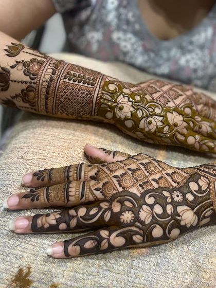 This image shows two different styles side-by-side, one with negative space and floral work, and the other with a dense traditional pattern.