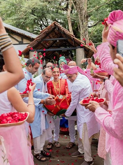 The bride is carried in a basket by her uncles, a fun and cherished tradition in many South Indian weddings.