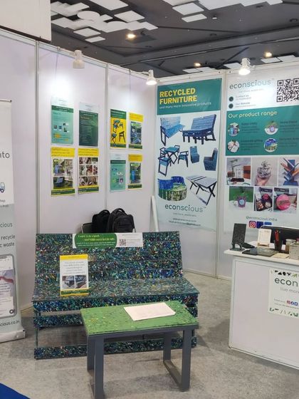 Another angle of our setup at PLAST INDIA 2023, showing our information panels that explain our mission, product range, and recycling process.