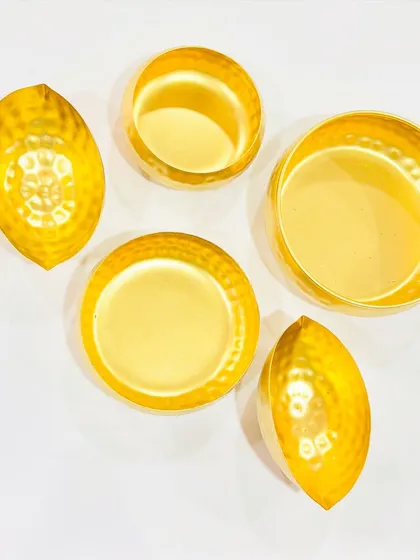 This image shows our collection of hammered urlis in various sizes and shapes, including round and leaf designs.