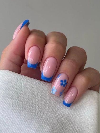 A lovely blue French manicure on square nails, with accent nails featuring delicate, hand-painted blue flowers.