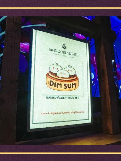 Our live stations feature fun and creative menus, including this adorable sign for our Rainbow Sweet Dimsum counter, adding a playful touch to your event.