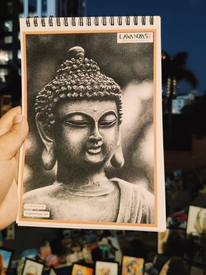 A charcoal portrait of the Buddha by Lavanya, another example of the high-caliber artwork featured at our community art events.