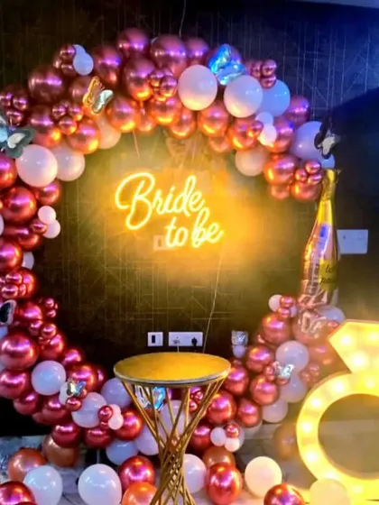 This 'Bride to be' setup is all about fun and glamour. I used a circular balloon arch with metallic rose gold and white balloons, a neon sign, and a large marquee light in the shape of a diamond ring. It’s a fantastic backdrop for a bachelorette party or bridal shower.