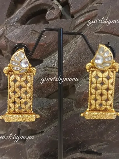 These unique Dakshinaya earrings feature a polki top with a base of intricate gold 'jaali' or lattice work, combining two distinct traditional styles into one beautiful piece.