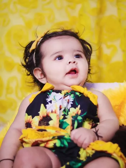 A curious and sweet expression from the baby girl during her sunflower session.