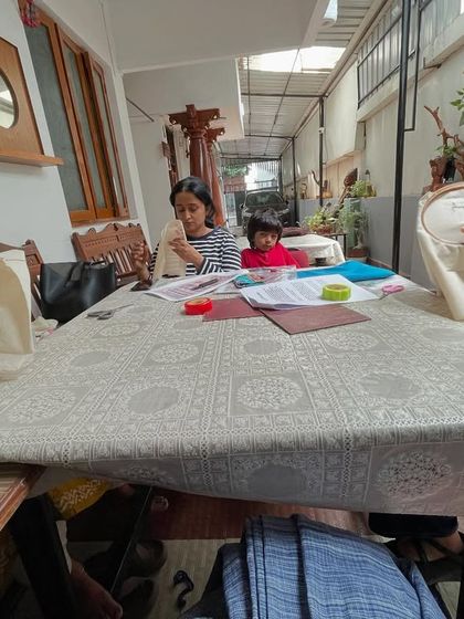 A wide view of an embroidery session, with students of different ages learning together. The intergenerational sharing of skills is one of the most rewarding aspects of my work.