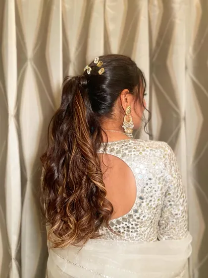 A textured ponytail with stone-encrusted clips. This is a great way to add a bit of sparkle and trendiness to a classic style.