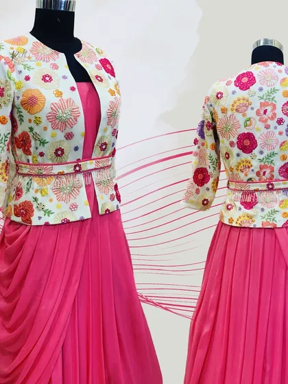A beautiful pink gown paired with a colorful, fully embroidered jacket. This fusion outfit is perfect for a sangeet or reception, combining comfort with intricate design.